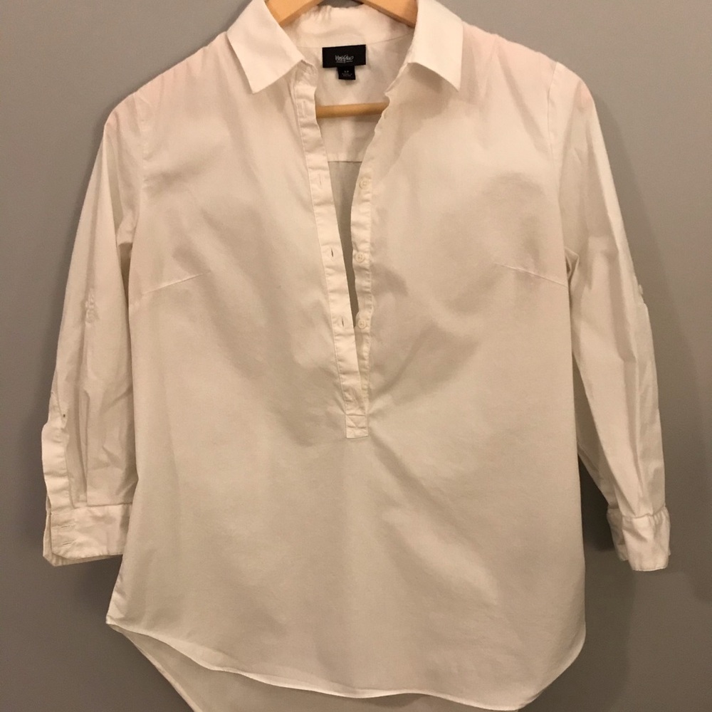 White collared shirt buttons halfway down